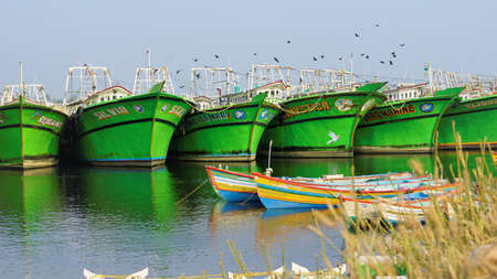 Colachel,Tamilnadu,India-December 23 2021: Boats and ships docked in Colachel Fishing harbor. Amazing view of silent harbour on christmas eveのeditorial素材