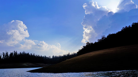 Beautiful view of Pykara Lake, Ooty, Tamilnadu. Awesome scenery of landscapes of sky,water and green bushes visible from boat ride. Best honeymoon destination in south india.の写真素材