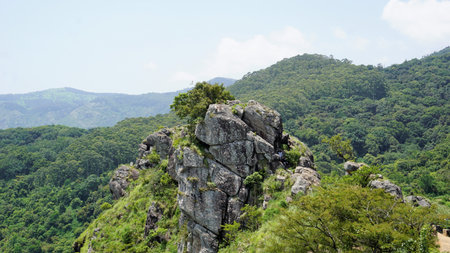 Ooty,Tamilnadu,India-June 04 2022: Tourists hiking in ooty to enjoy the sightseeing place Needle Rock view point or suicide point. Best hiking place covered with mist, natural forest and mountain landscape.のeditorial素材