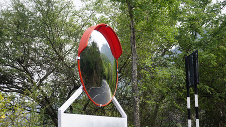Outdoor traffic convex mirror in the hairpin bends and uphill road enroute to kodaikanal hilltop. Installed for improving safety.の写真素材