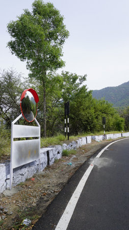 Outdoor traffic convex mirror in the hairpin bends and uphill road enroute to kodaikanal hilltop. Installed for improving safety.の写真素材