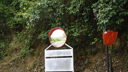Outdoor traffic convex mirror in the hairpin bends and uphill road enroute to kodaikanal hilltop. Installed for improving safety.の写真素材