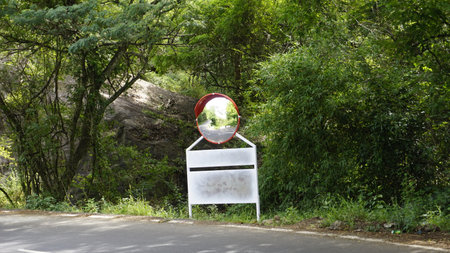 Outdoor traffic convex mirror in the hairpin bends and uphill road enroute to kodaikanal hilltop. Installed for improving safety.の写真素材