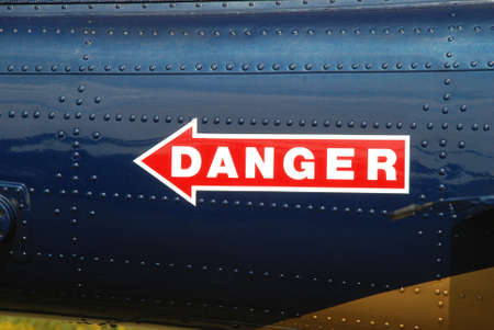 red danger sign painted on a blue backgroundの写真素材