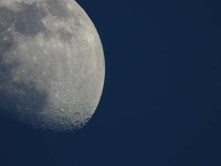 Moon by day, detailed craters visible
