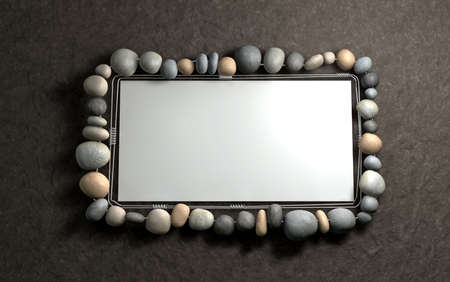 A contempory handmade wire and stone picture frame hanging on a wallの写真素材