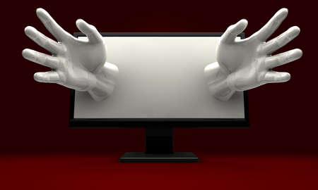 A pair of hands reaching out from a lcd computer monitor encroaching on the userの写真素材