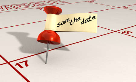 A calendar with an attached red thumbtack with a tape tag and the words save the date written in black markerの写真素材