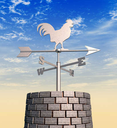 A regular metal weathervane with a cockeral motif facing north on brick chimney against a blue sunny...