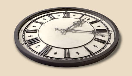 An antique clock  with roman numerals and ornate metal hands on an isolated backgroundの写真素材