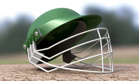 A regular green plastic cricket helmet on a cracked cricket pitch with white markingsの写真素材