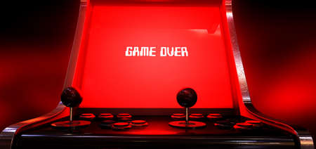 A vintage arcade game machine with a bright red illuminated screen that reads game over in white on...