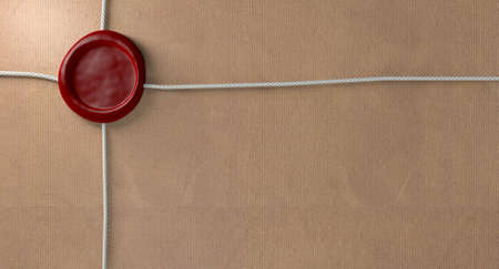 A closeup of a parcel wrapped in brown paper bound by a thin string and sealed by a blank red wax...