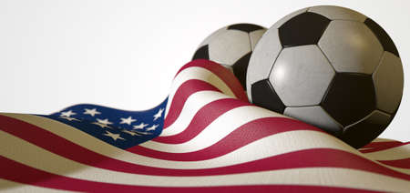 A regular stitched panel soccer ball resting on a draped american flag on an isolated white studio backgroundの写真素材