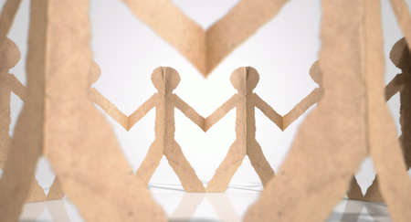 A circle of brown cardboard cutout men on an isolated white studio backgroundの写真素材