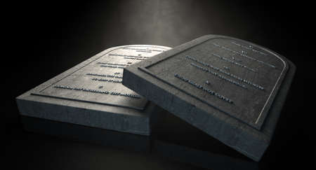 Two representative stone tablets with the ten commandments inscribed on them on an isolated dark ethereal backgroundの写真素材