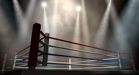 A regular boxing ring surrounded by ropes spotlit by various lights on an isolated dark backgroundの写真素材