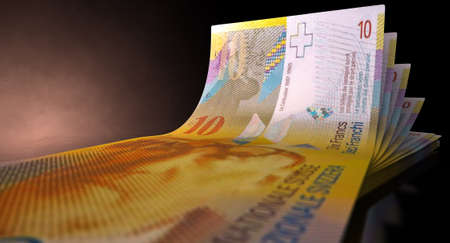 A group of five swiss franc banknotes fanned out and curved on an isolated white background