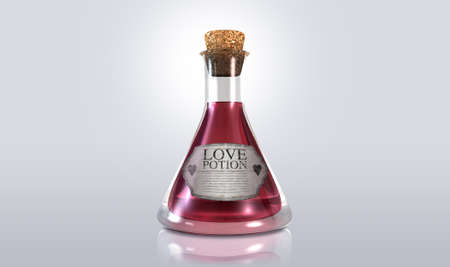 A regular old goblet glass bottle filled with a pink liquid with a label showing it is love potion and sealed with a cork on an isolated backgroundの写真素材