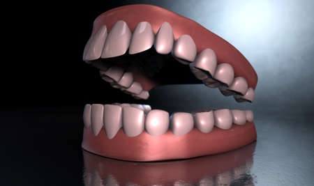 A sinister dramatic depiction of seperated upper and lower sets of human teeth set in gums on a dark...