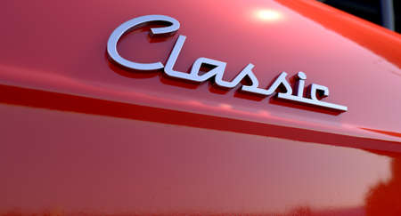 A closeup view of the word classic writing as a chrome emblem in a retro font の写真素材