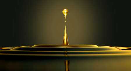 An extreme close up of a drop of oil creating ripples on an isolated black backgroundの写真素材