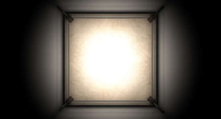 An old vintage boxing ring surrounded by ropes spotlit in the middle on an isolated dark backgroundの写真素材