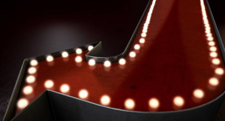 A belle epoque era red vintage arrow sign light by lightbulbs on an isolated dark backgroundの写真素材