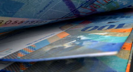 A macro close-up view showing the detail inbetween two separated swiss franc banknotesの写真素材