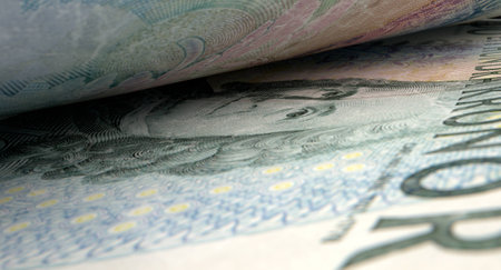 A macro close-up view showing the detail inbetween two separated swedish kronor banknotesの写真素材