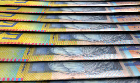 A macro close-up view showing the detail of australian dollar banknotes laid out and overlapping in a staggered rowの写真素材