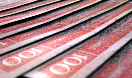 A macro close-up view showing the detail of malaysian hong kong dollar banknotes laid out and overlapping in a staggered rowの写真素材