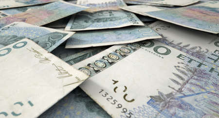 A macro close-up view of a messy scattered pile of swedish kronor banknotes