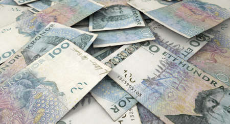 A macro close-up view of a messy scattered pile of swedish kronor banknotesの写真素材