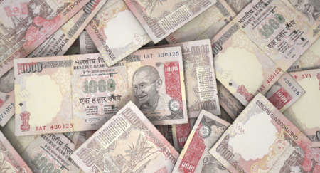 A macro close-up view of a messy scattered pile of indian rupee banknotes