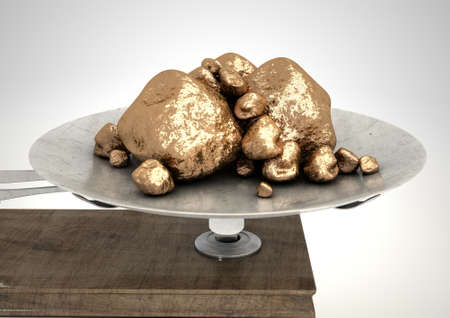 An old metal and wood two pan balance scale with gold nuggets in  on side on an isolated white backgroundの写真素材