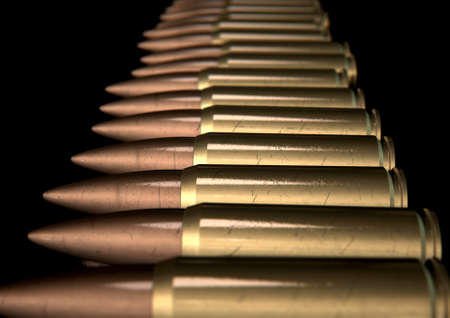 A macro close up view of a row of regular scratched brass and copper bullets on an isolated black...