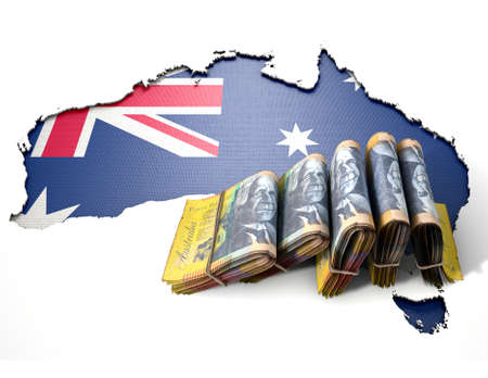 The shape of the country of Australia in the colours of its national flag recessed into an isolated white surface with a wad of folded Australian Dollar notes resting on itの写真素材