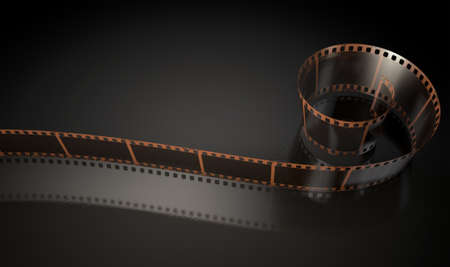A strip of blank old vintage camera film curled up on an isolaed studio backgroundの写真素材