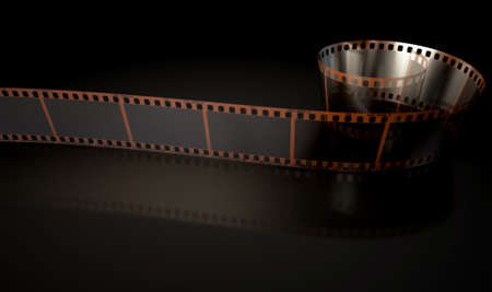 A strip of blank old vintage camera film curled up on an isolaed studio backgroundの写真素材