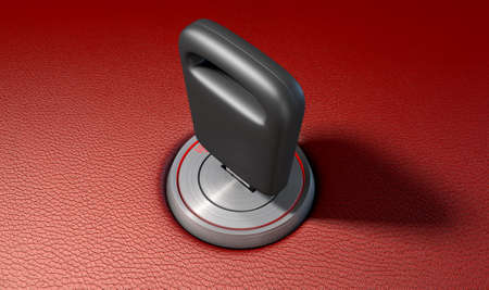 A modern chrome and blue light car ignition with a simple key inserted on a red leather surface