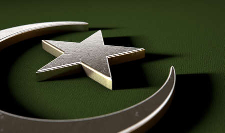 A metal islamic crescent moon and star on a green textured backgroundの写真素材