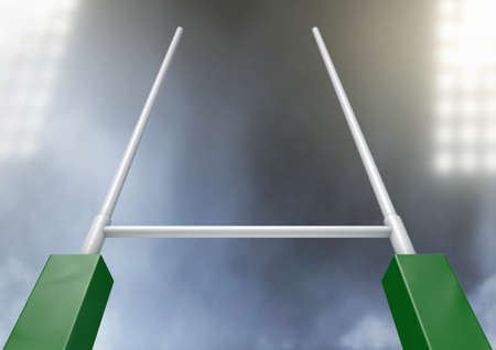 A closeup of rugby posts in a stadium under floodlights at nightの写真素材