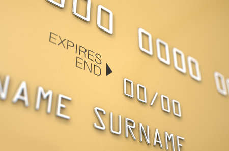 A closeup view of a gold generic blank bank credit card on an isolated white studio backgroundの写真素材