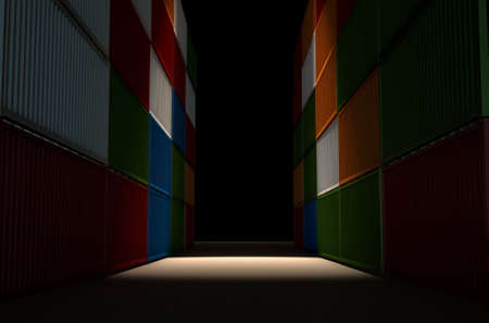 A corridor bewteen two rows of stacked colorful metal freight shipping containersの写真素材