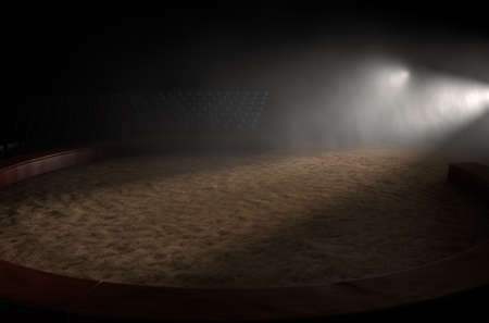 A 3D render of an empty classic circus arena backlit by dramatic spot lights on a dark moody backgroundの写真素材