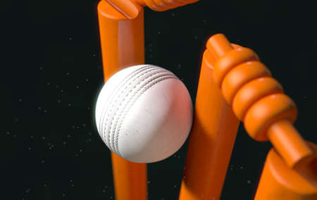 A close up of a white leather stitched cricket ball hitting orange wickets with dirt particles emanating from the impact at night - 3D renderの写真素材