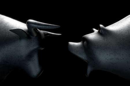 A closeup of two metal castings depicting a stylized bull opposing a bear in dramatic light representing  financial market trends on an isolated dark background - 3D renderの写真素材