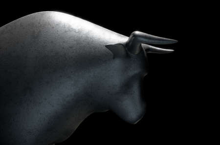 A closeup of a metal casting depicting a stylized bull in dramatic light representing financial market trends on an isolated dark background - 3D renderの写真素材