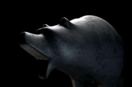A closeup of a metal casting depicting a stylized bear in dramatic light representing financial market trends on an isolated dark background - 3D renderの写真素材